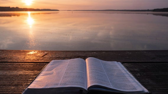 book on top of table and body of water